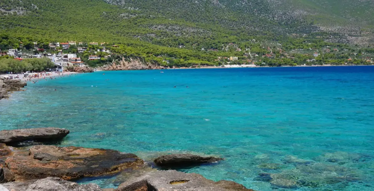 Panoramic aerial view of Porto Germeno bay, village, and surrounding mountains