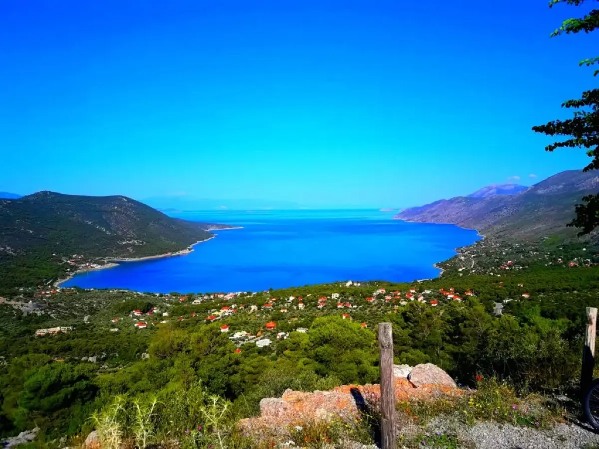 Deep blue Porto Germeno bay seen from a hillside viewpoint above the village