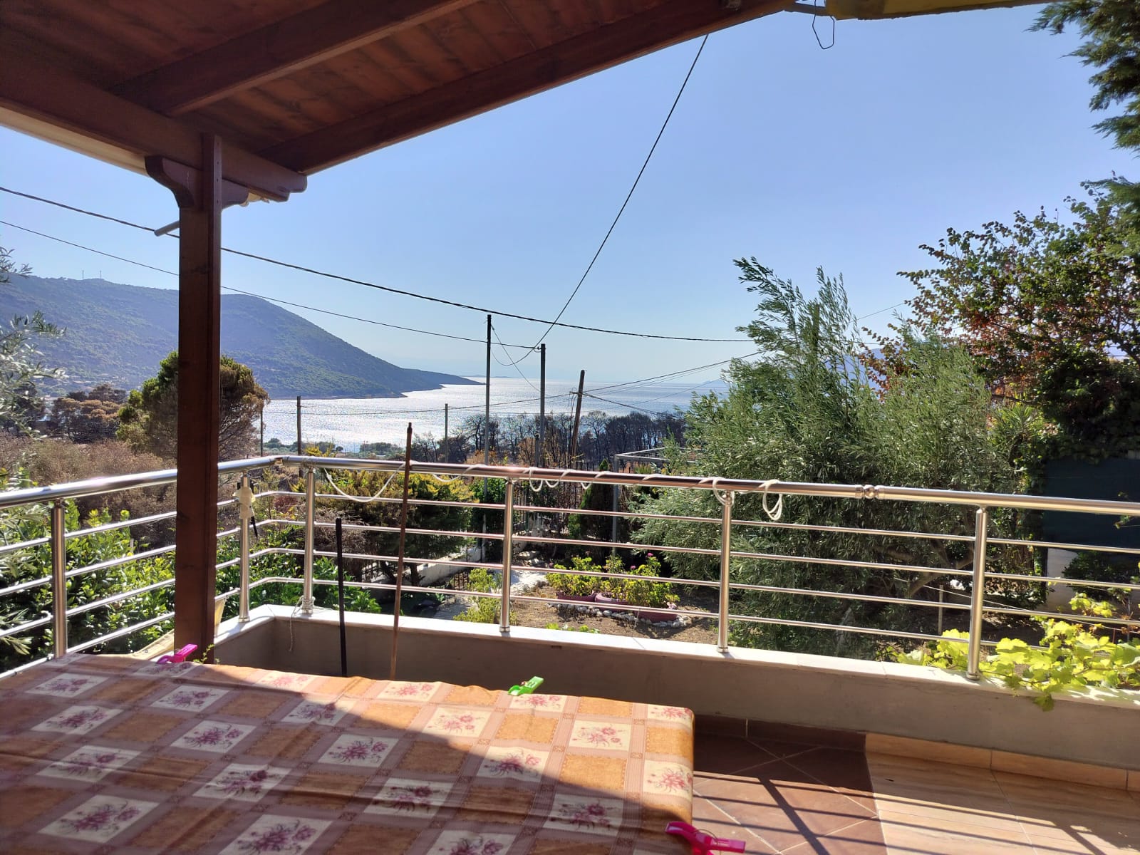 Covered terrace with panoramic sea and mountain view at Porto Germeno Hotel